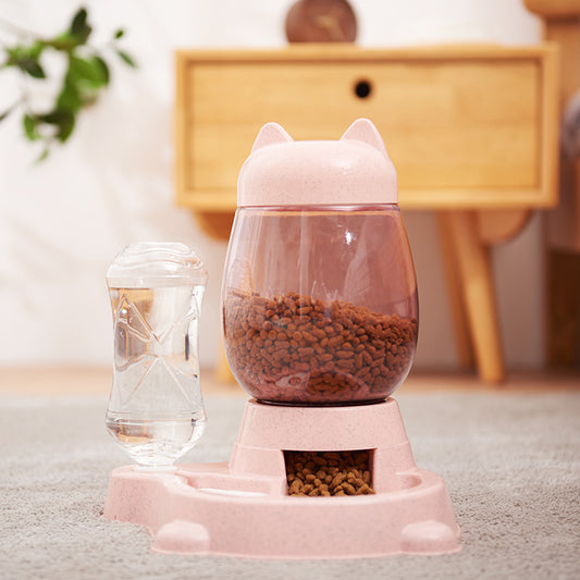 Pink Automatic Pet Feeder in Home Setting - Cat Ear Design with Food and Water Dispensers, Cozy Interior Background
